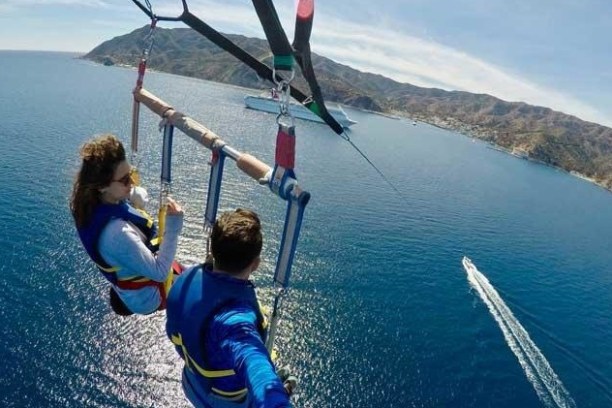 a man flying through the air over a body of water