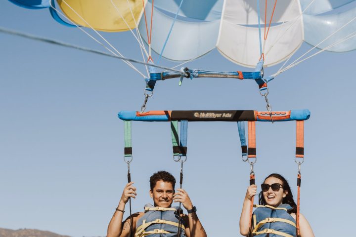 a man standing next to a body of water