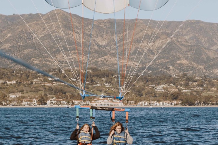 a man flying a kite in a boat on the water